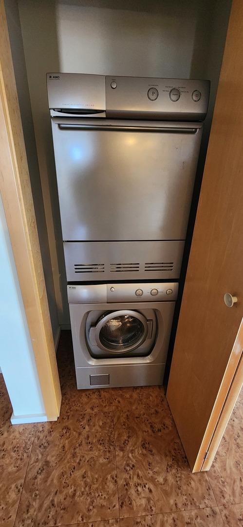 washroom with stacked washer / drying machine