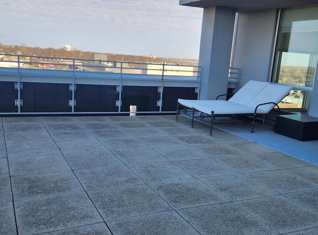 view of patio featuring a balcony