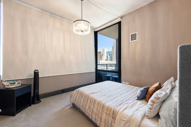 carpeted bedroom featuring a chandelier