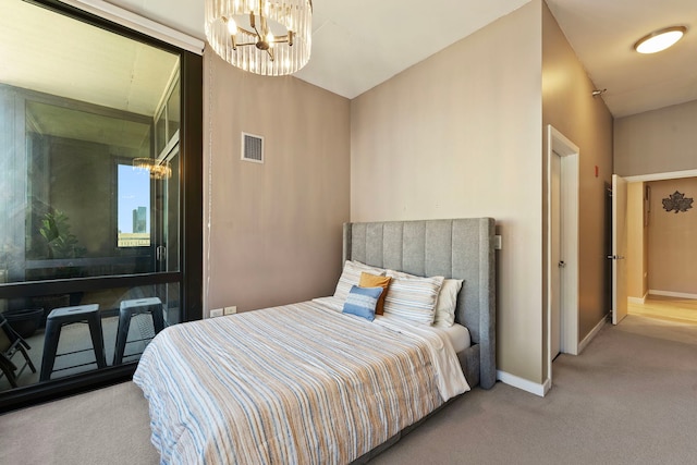 bedroom featuring light colored carpet and a chandelier