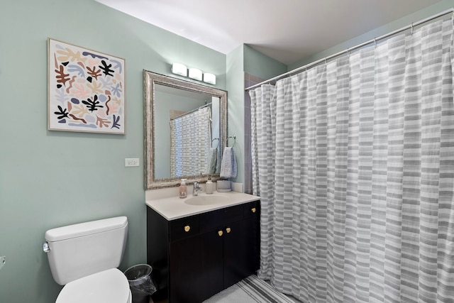 bathroom with vanity, curtained shower, and toilet