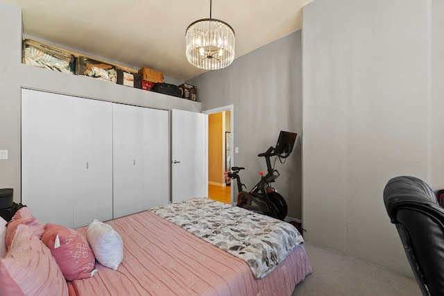 carpeted bedroom with a closet and a notable chandelier