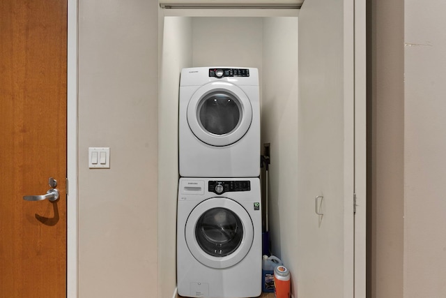 clothes washing area with stacked washer and dryer