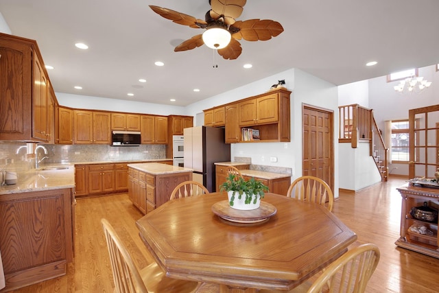 dining area with stairs, recessed lighting, light wood-style floors, and ceiling fan