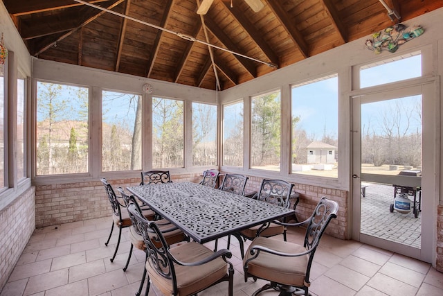 sunroom featuring lofted ceiling with beams and wooden ceiling