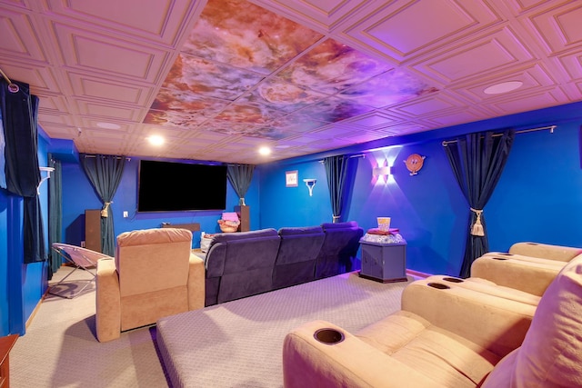 carpeted home theater room featuring an ornate ceiling