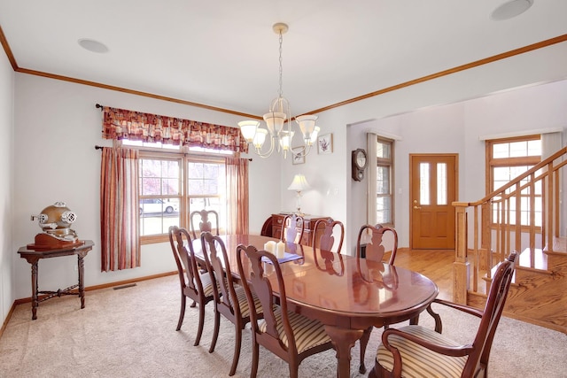 dining space with a healthy amount of sunlight, a chandelier, and ornamental molding