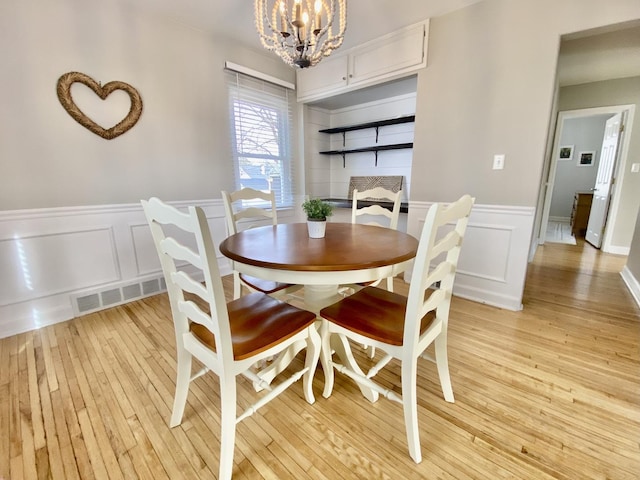 dining room featuring a chandelier and light hardwood / wood-style floors