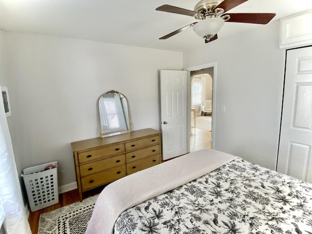 bedroom with hardwood / wood-style flooring, a closet, and ceiling fan