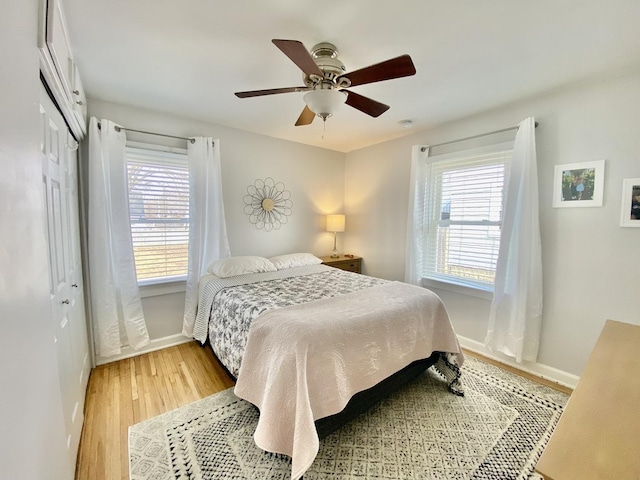 bedroom featuring hardwood / wood-style flooring, ceiling fan, and a closet