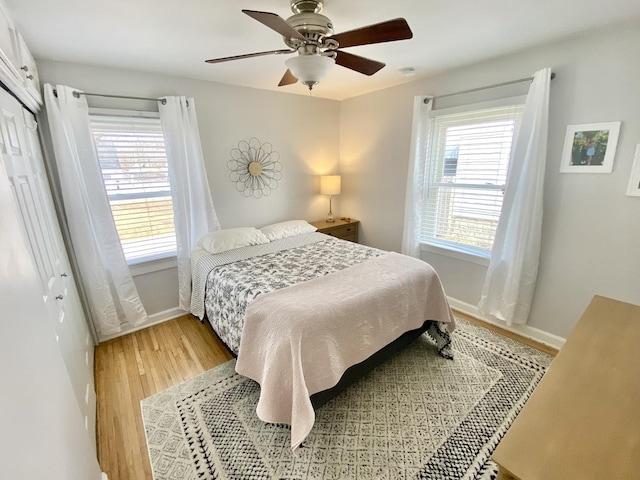 bedroom featuring hardwood / wood-style floors, ceiling fan, and a closet