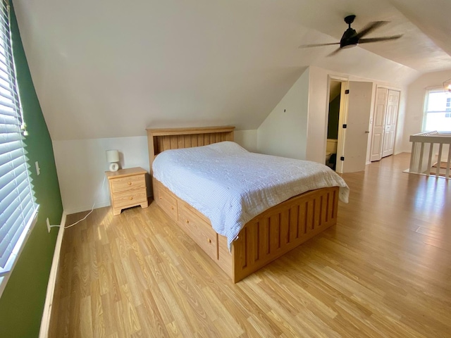 bedroom featuring ceiling fan, lofted ceiling, and light hardwood / wood-style flooring