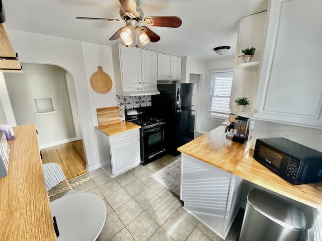 kitchen featuring butcher block countertops, white cabinetry, light tile patterned floors, ceiling fan, and black appliances