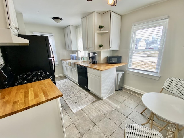 kitchen featuring butcher block countertops, sink, white cabinets, ceiling fan, and black appliances