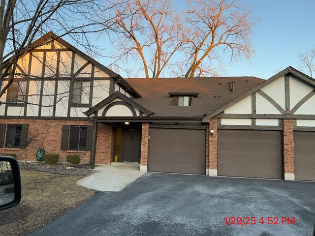 tudor-style house with a garage