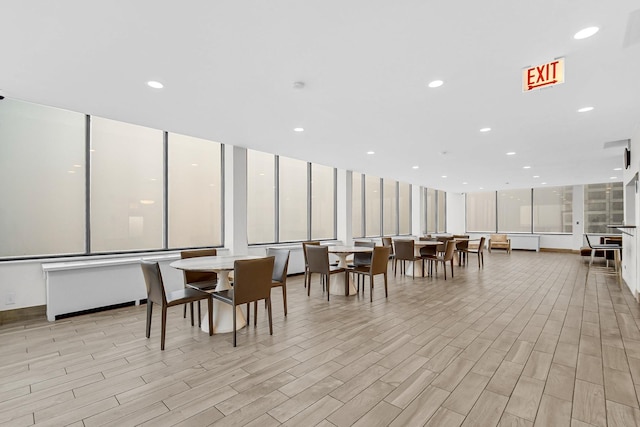 dining area with light wood-style floors and recessed lighting