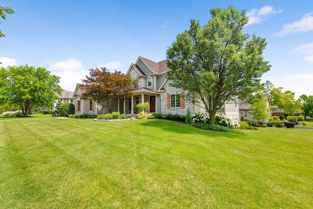 view of front of property featuring stone siding and a front lawn