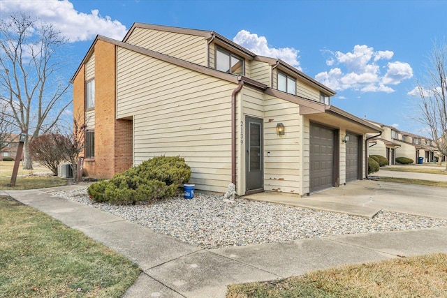 view of property exterior with cooling unit and a garage