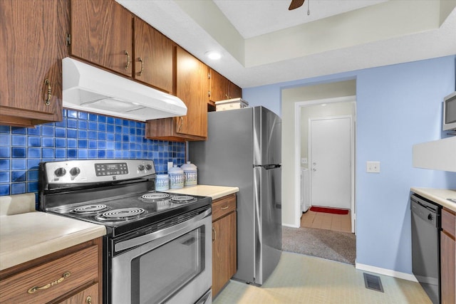 kitchen featuring backsplash, stainless steel appliances, ceiling fan, and light tile patterned flooring