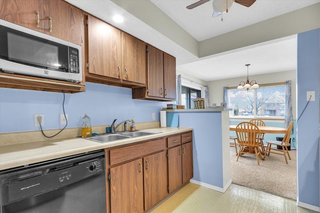 kitchen featuring sink, decorative light fixtures, a textured ceiling, dishwasher, and ceiling fan with notable chandelier