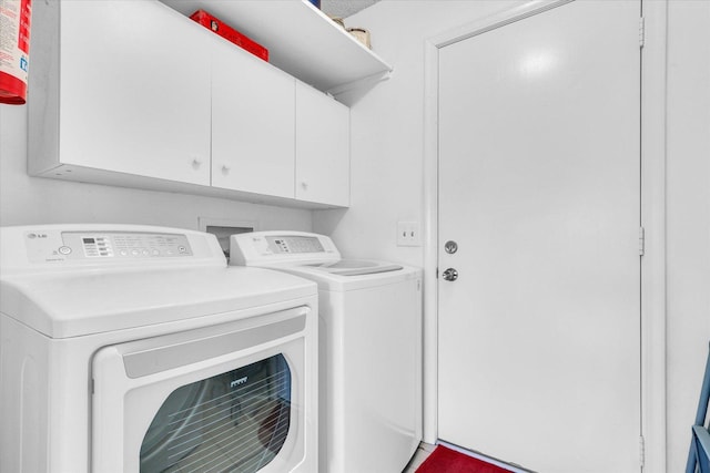 laundry room with cabinets and washer and clothes dryer