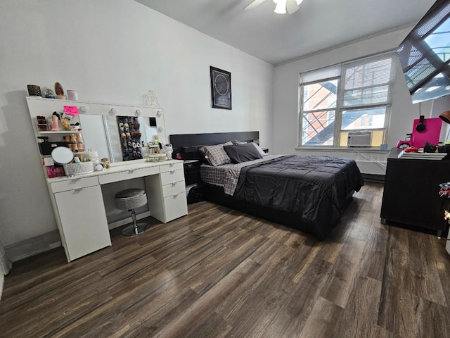 bedroom featuring a ceiling fan, cooling unit, and dark wood-style flooring