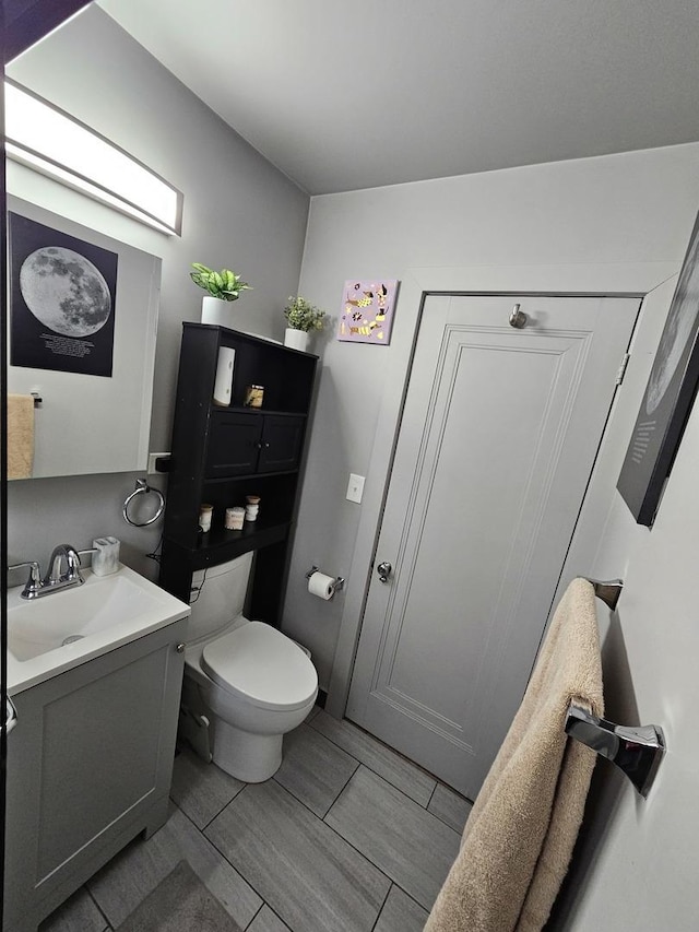 half bath with vanity and toilet