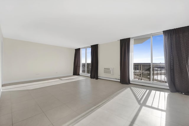 empty room featuring light tile patterned floors, a wall mounted AC, a wall of windows, and baseboard heating