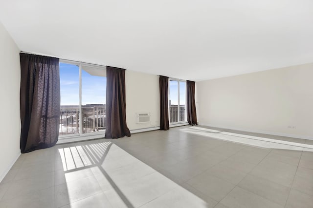 empty room with expansive windows and a wall unit AC