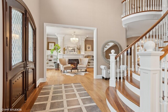 6 Ivy Ln, Oak Brook, IL 60523 - foyer featuring stairway, baseboards, a high ceiling, and wood finished floors