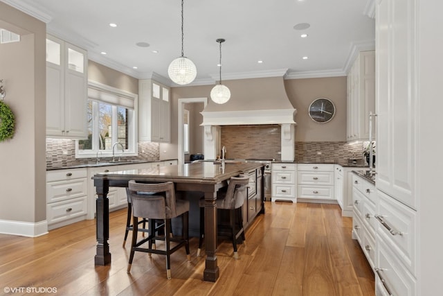 6 Ivy Ln, Oak Brook, IL 60523 - kitchen featuring backsplash, custom exhaust hood, white cabinets, and a breakfast bar