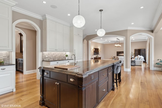 6 Ivy Ln, Oak Brook, IL 60523 - kitchen with arched walkways, dark countertops, recessed lighting, and dark brown cabinetry