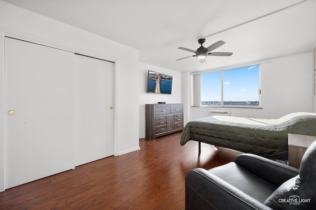 bedroom with dark wood-type flooring, a closet, and ceiling fan