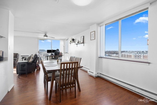 dining space with ceiling fan, dark hardwood / wood-style floors, and baseboard heating