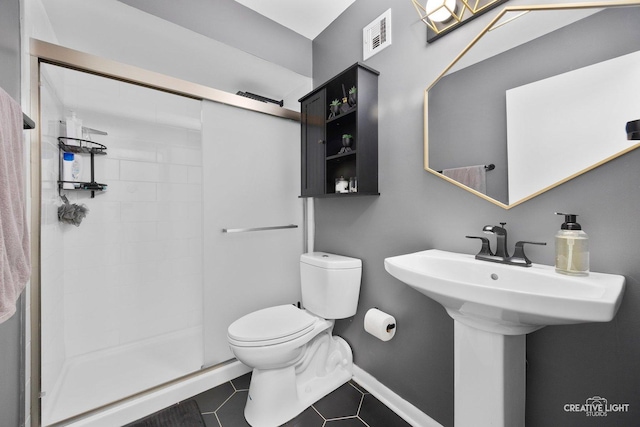 bathroom featuring an enclosed shower, tile patterned floors, and toilet