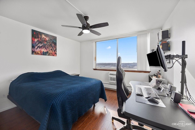 bedroom with dark wood-type flooring, a baseboard radiator, and ceiling fan