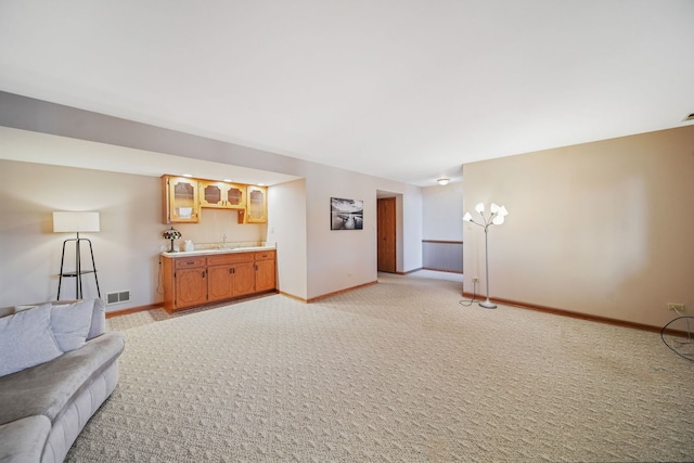 carpeted living room featuring sink