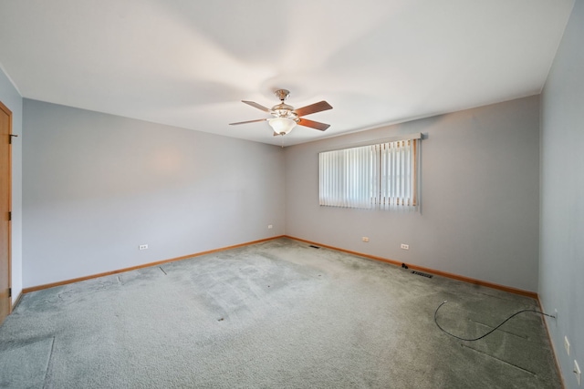 empty room featuring carpet floors and ceiling fan