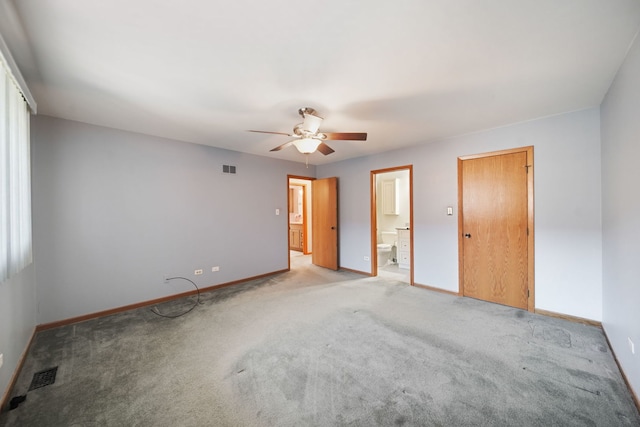 carpeted spare room with ceiling fan