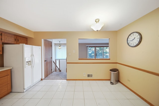 kitchen featuring white refrigerator with ice dispenser