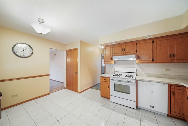 kitchen featuring tasteful backsplash and white appliances