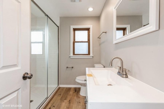 bathroom featuring an enclosed shower, hardwood / wood-style floors, vanity, and toilet