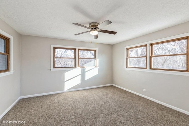 unfurnished room with a healthy amount of sunlight, baseboards, and carpet floors