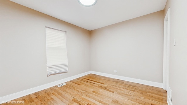 unfurnished room with wood-type flooring