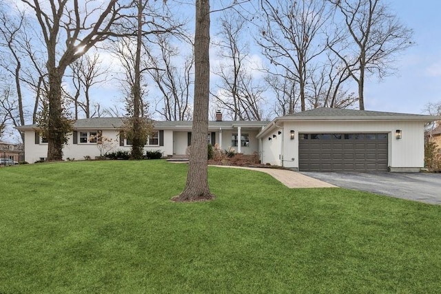 ranch-style home featuring a garage and a front yard