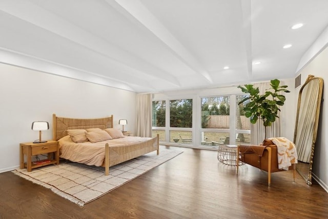 bedroom with beamed ceiling and light hardwood / wood-style floors