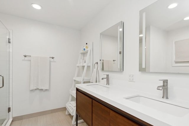 bathroom featuring walk in shower and vanity