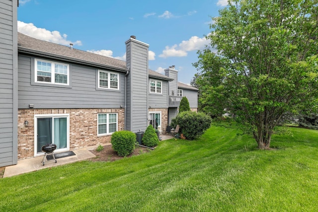 back of house with a patio area, a yard, and central air condition unit