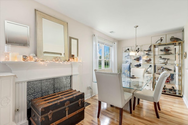 dining space with hardwood / wood-style floors and a chandelier