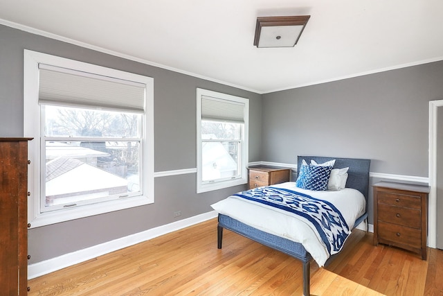 bedroom with wood-type flooring and ornamental molding